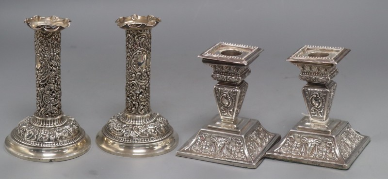 Two pairs of late Victorian silver dwarf candlesticks,